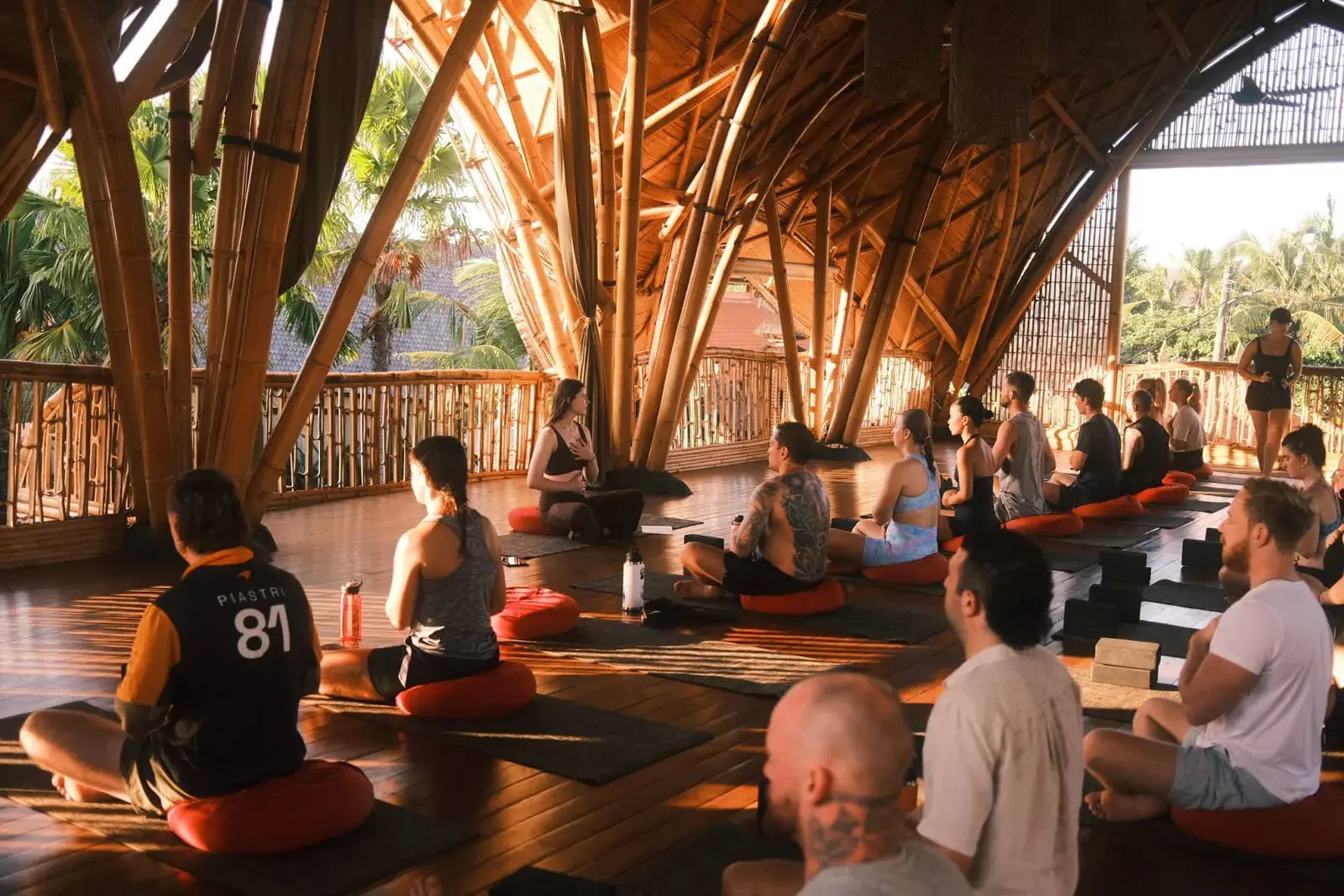 Founders in a sunrise yoga session inside the bamboo shala